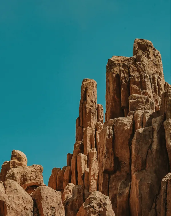 A large rock formation against a backdrop of the sky. It is an outdoor scene featuring a prominent natural rock structure.