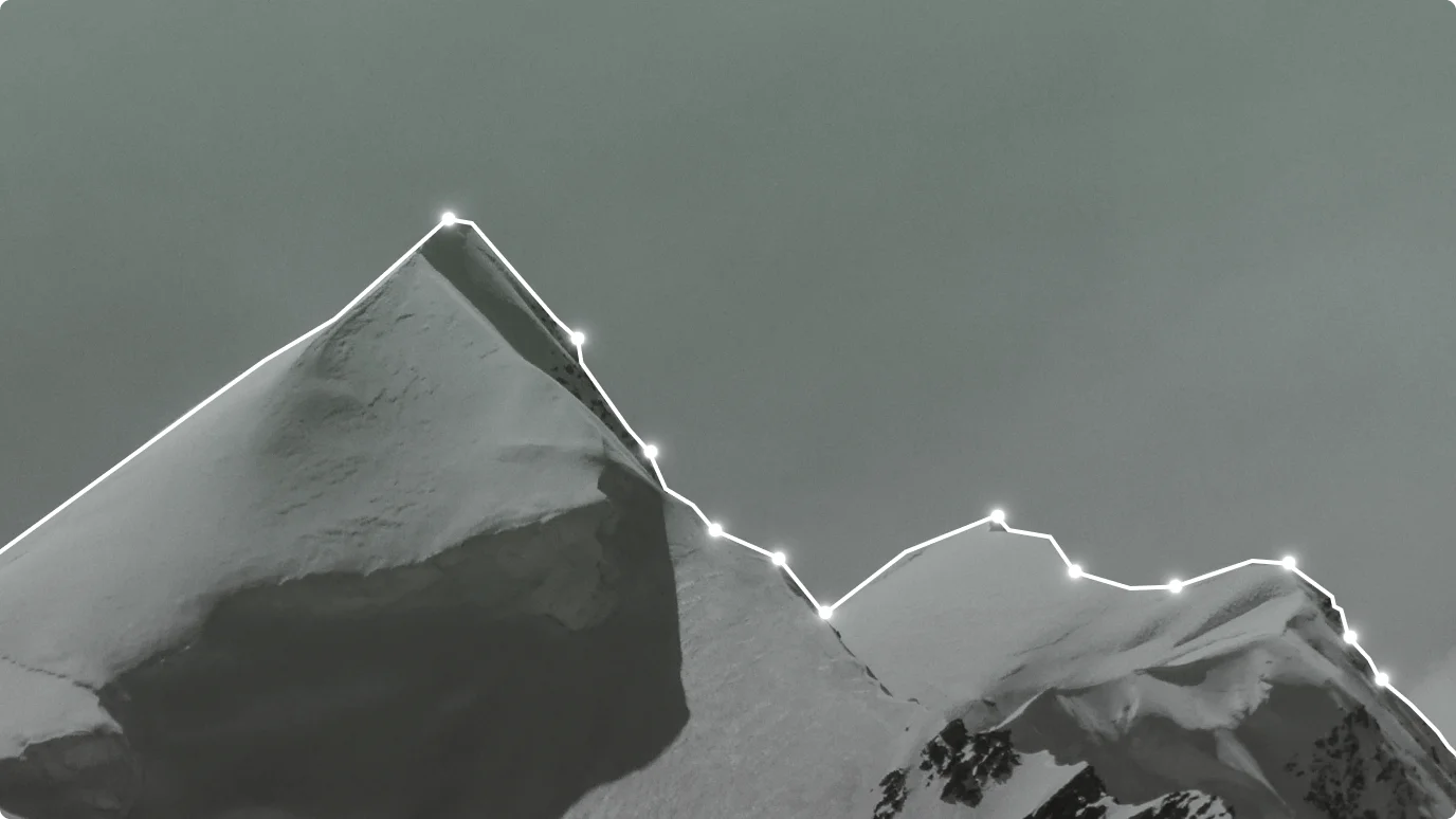 A snow-covered mountains with a cloudy sky.
