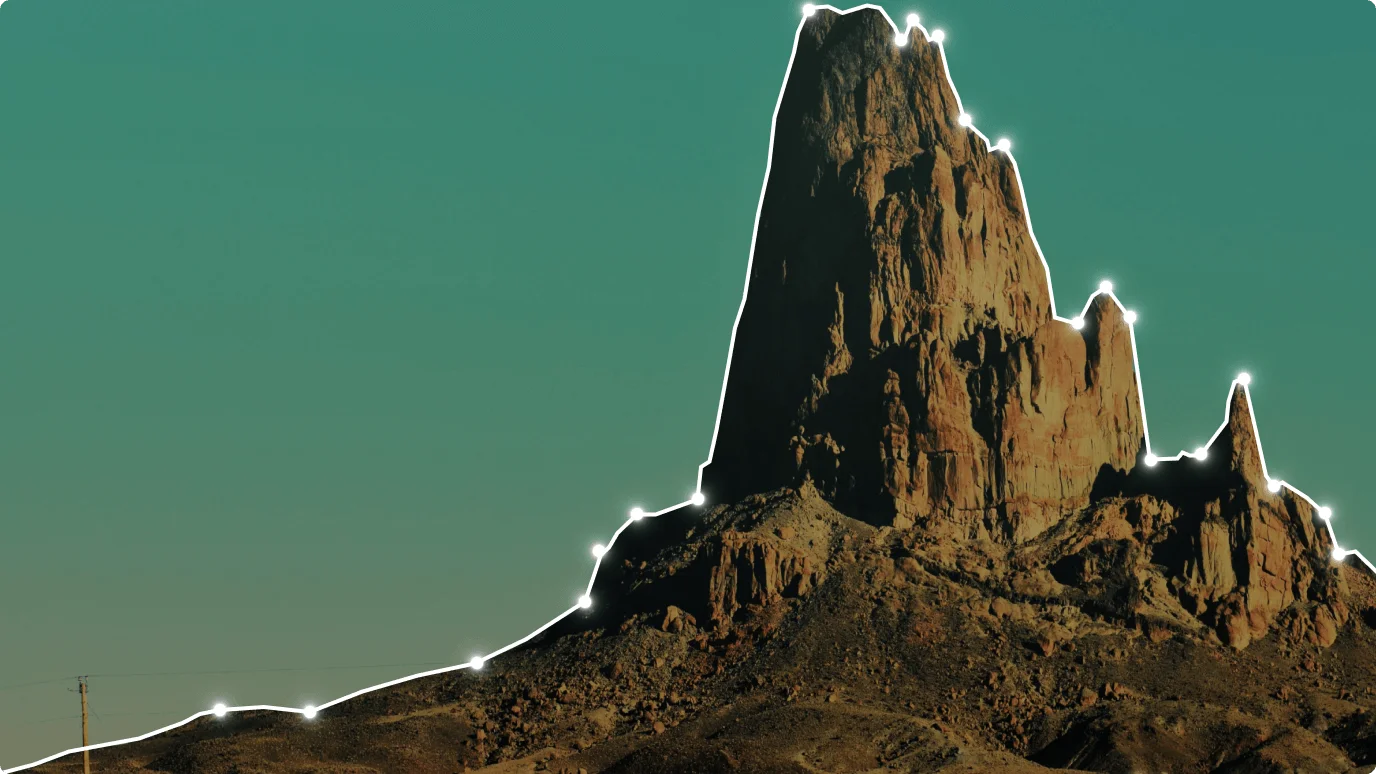 A scenic landscape with a cliff showcasing a beautiful outdoor scene with a mountainous backdrop and a clear sky.